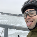Cyclist in winter sticking tongue out